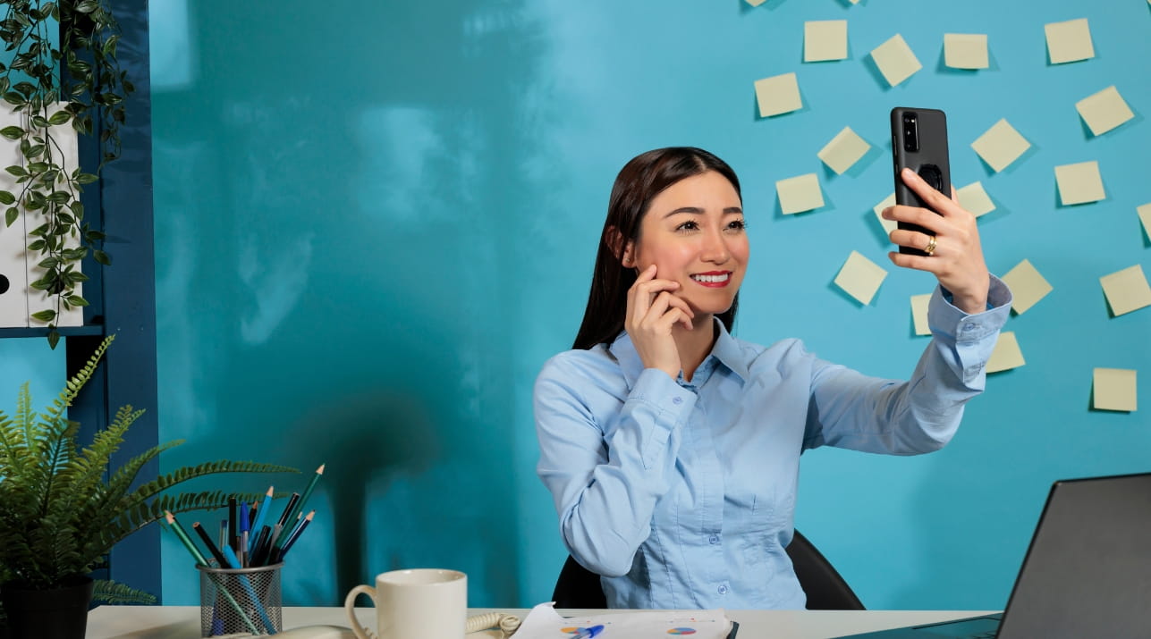 woman taking selfie office